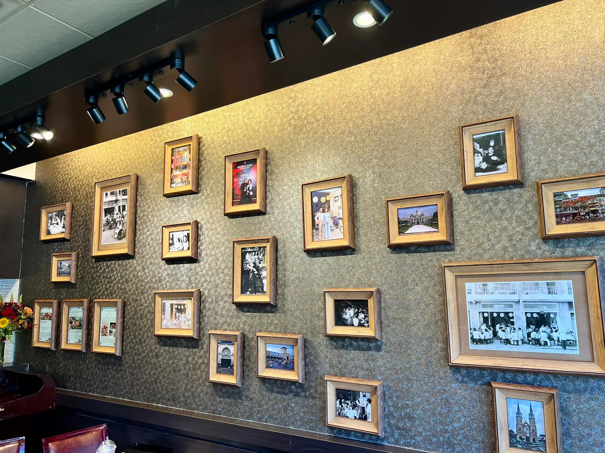 A wall of framed photos from the Hồng Phát family archive and old Saigon